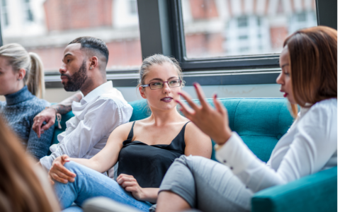 young adults sit together and talk