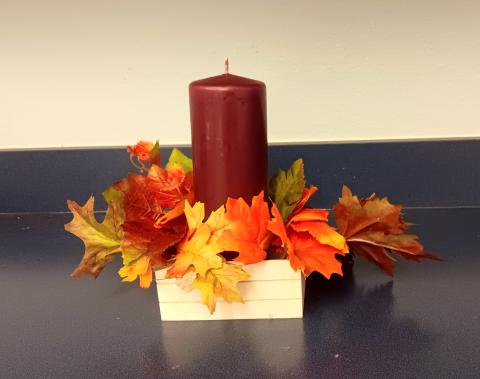 centerpiece with candle and leaves