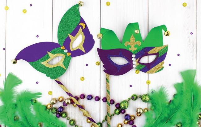 Picture of two green and purple Mardi Gras masks